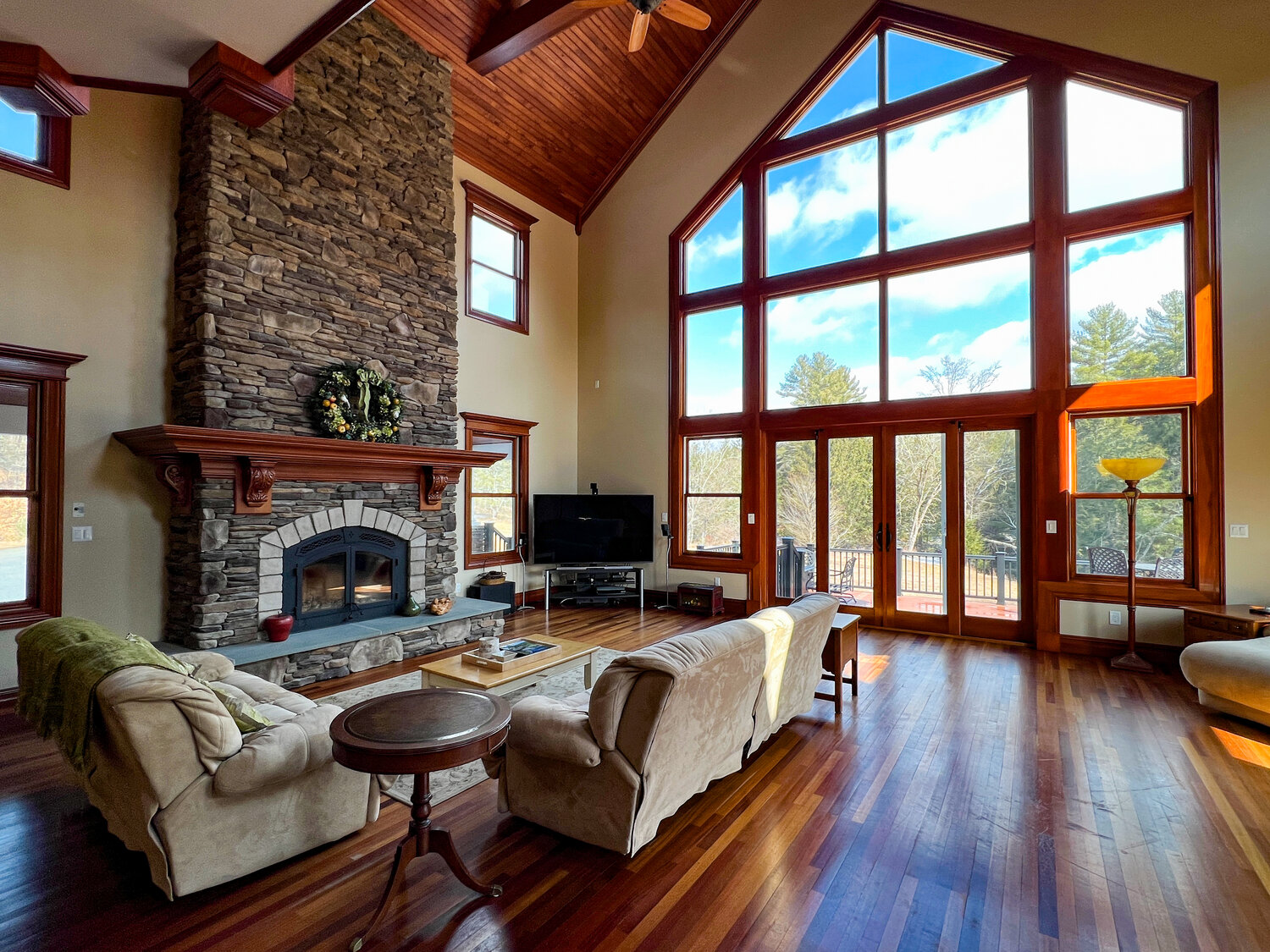 A cherrywood cathedral ceiling, wall of windows and stacked-stone fireplace are the highlights of the great room...
